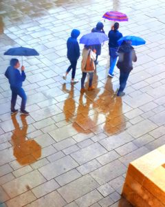 People with umbrellas walking in the rain